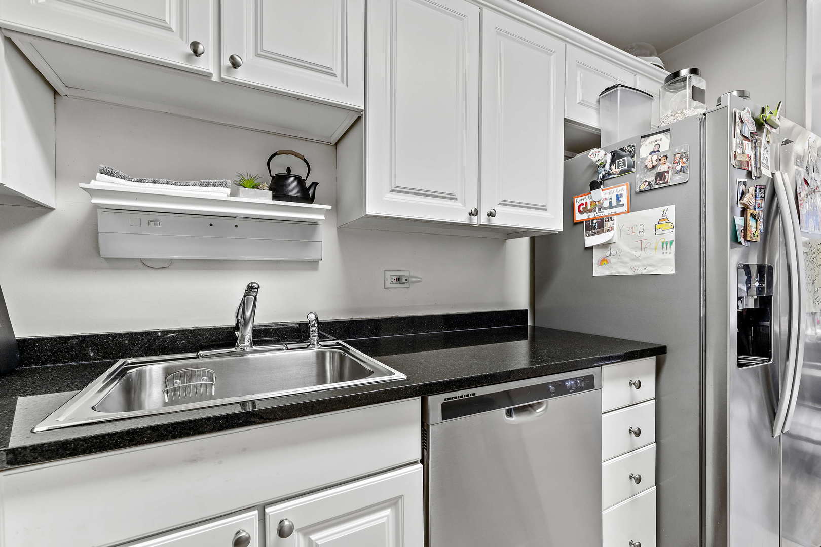 655 West Irving Park Road, Unit 515 Chicago, IL 60613 - Photo 9 of 22 a kitchen with stainless steel appliances granite countertop a sink and cabinets