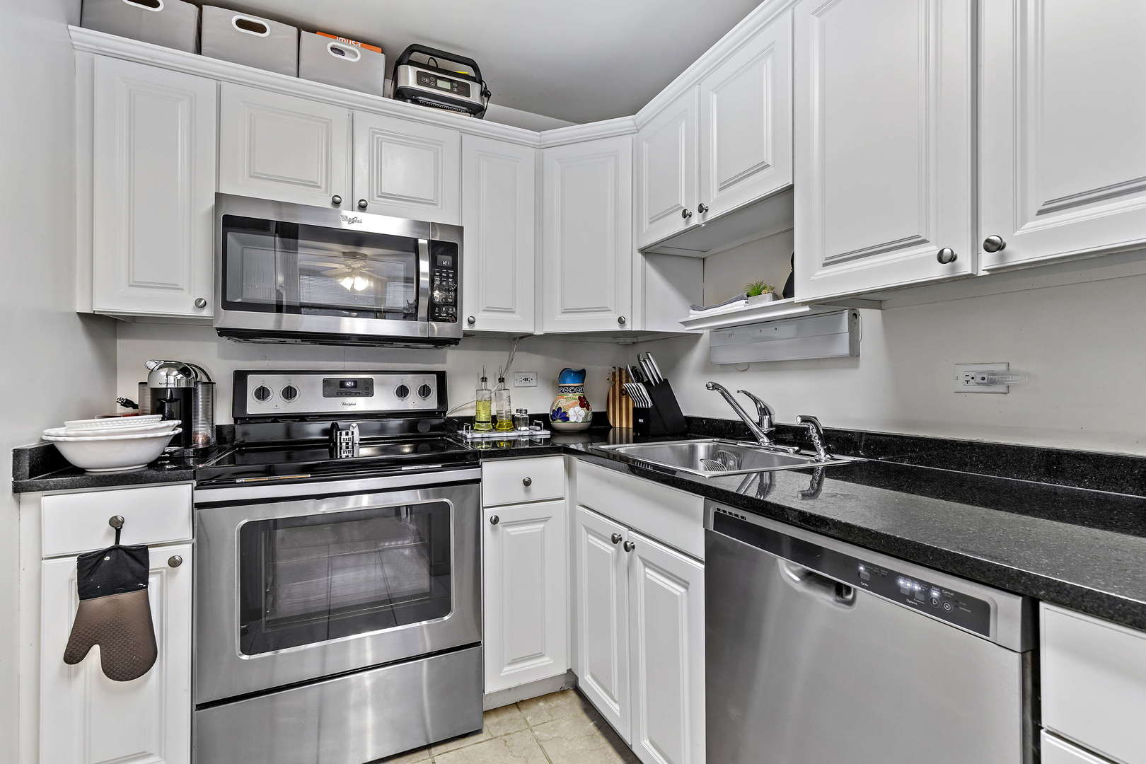 655 West Irving Park Road, Unit 515 Chicago, IL 60613 - Photo 10 of 22 a kitchen with stainless steel appliances granite countertop grey cabinets a stove a sink and dishwasher