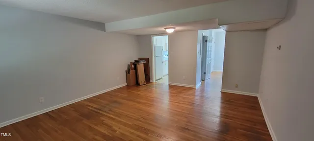 a view of hallway with wooden floor
