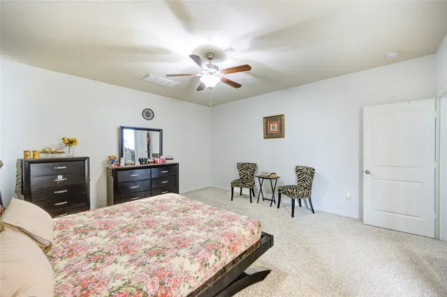 a bed room with a bed and a chair