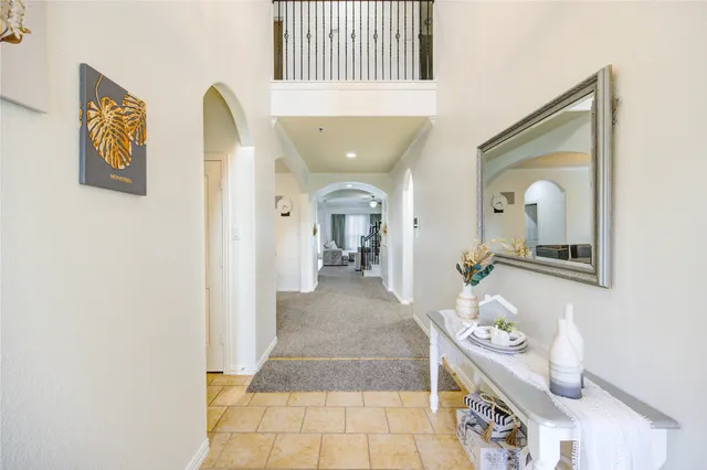 a living room with a baby crib furniture and a chandelier