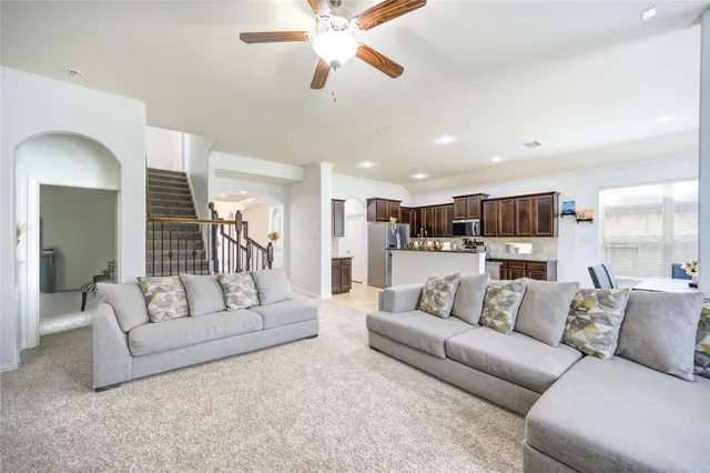 a view of a living room kitchen and a chandelier