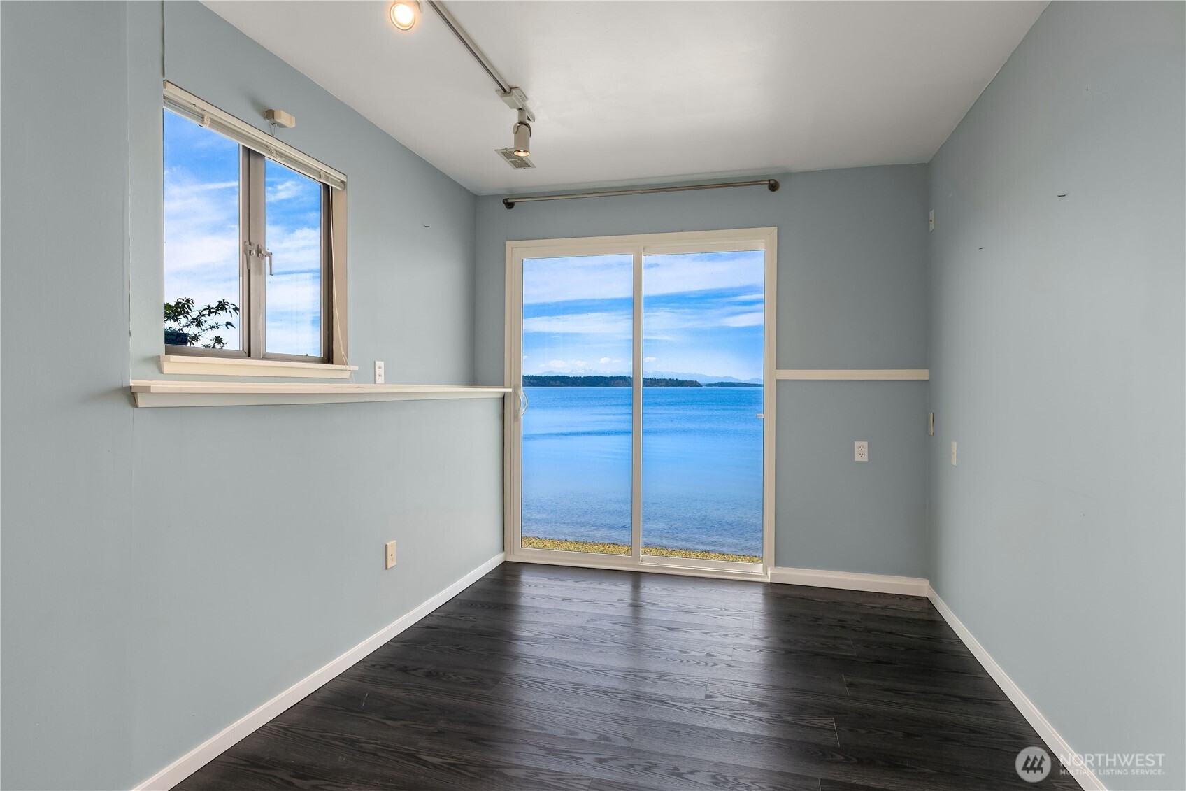 16611 Maplewild Avenue Southwest Burien, WA 98166 - Photo 13 of 40 an empty room with wooden floor and windows