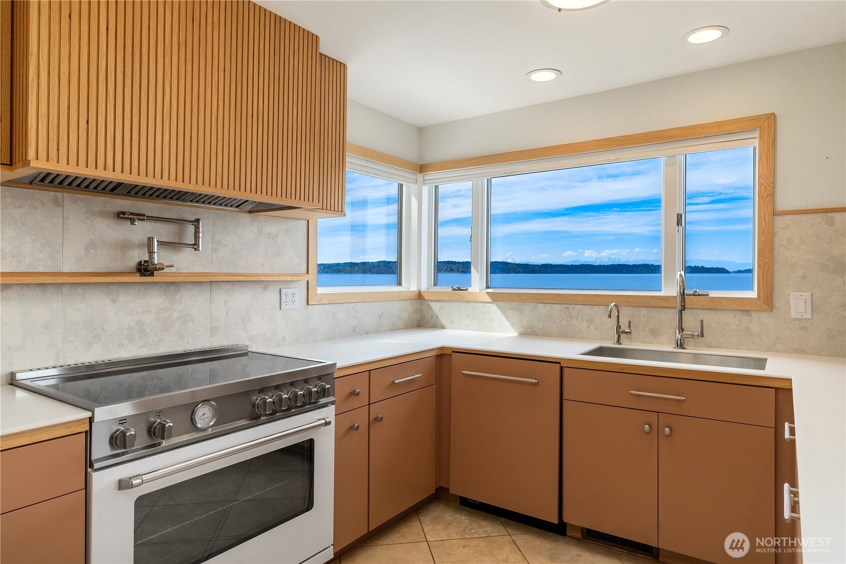 16611 Maplewild Avenue Southwest Burien, WA 98166 - Photo 20 of 40 a kitchen with a sink stove and cabinets