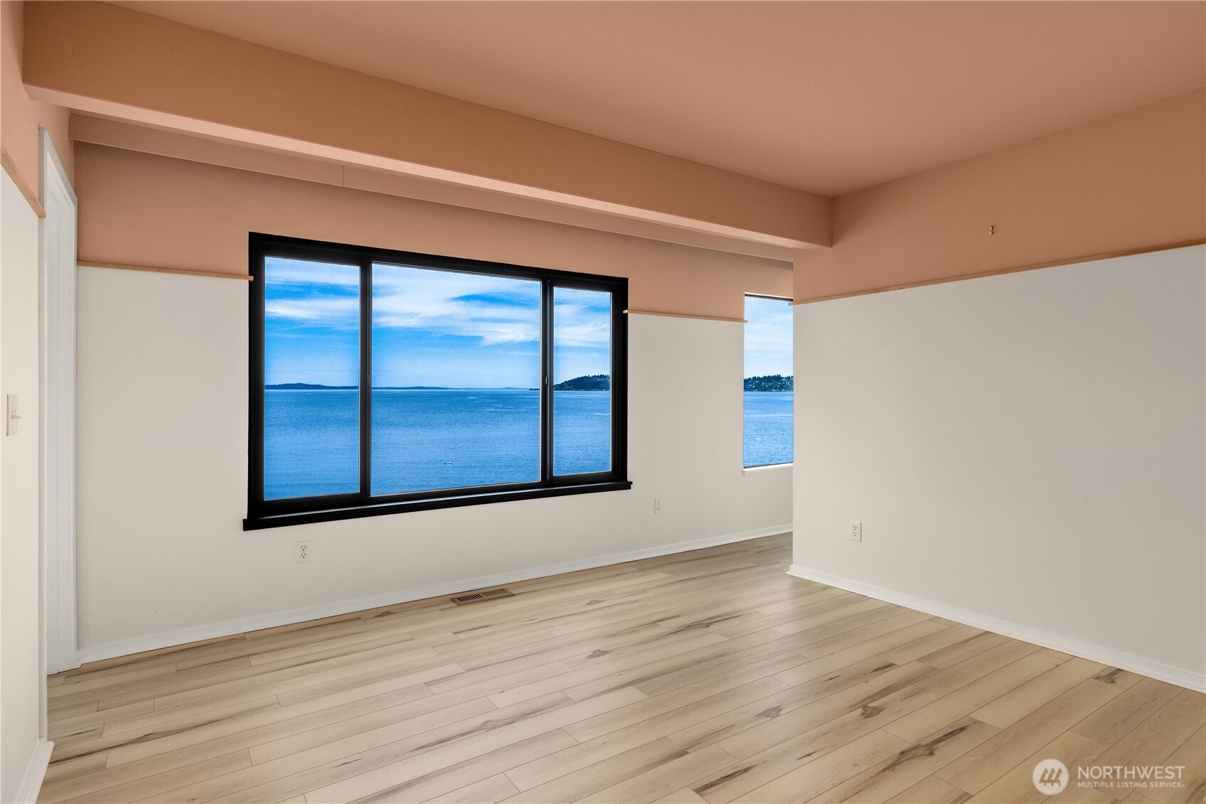 16611 Maplewild Avenue Southwest Burien, WA 98166 - Photo 22 of 40 a view of an empty room with wooden floor and a window