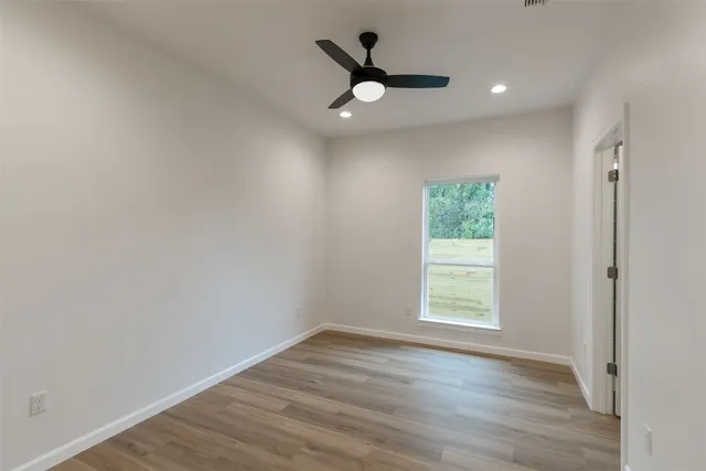 wooden floor in an empty room with a window