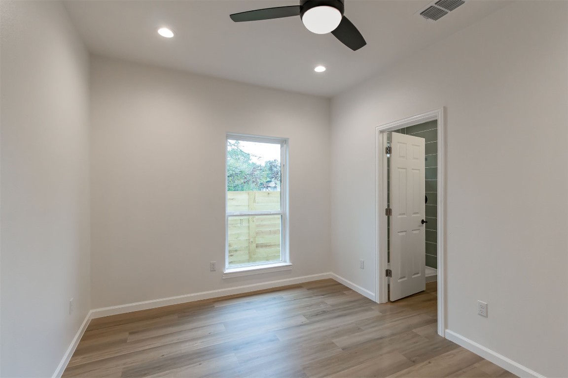 508 Brown Street Lockhart, TX 78644 - Photo 12 of 18 an empty room with wooden floor and windows