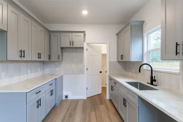 a kitchen with a sink and cabinets