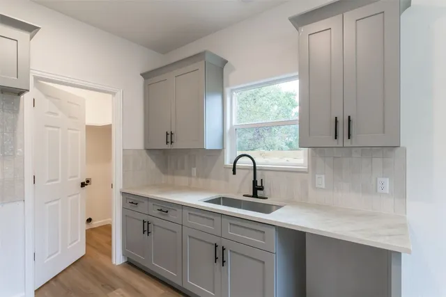 a kitchen with a sink cabinets and window