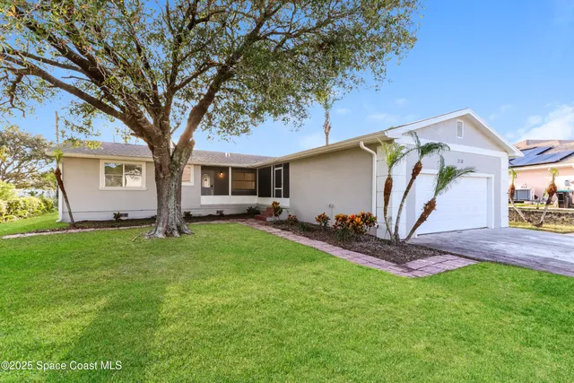 a front view of house with yard and green space