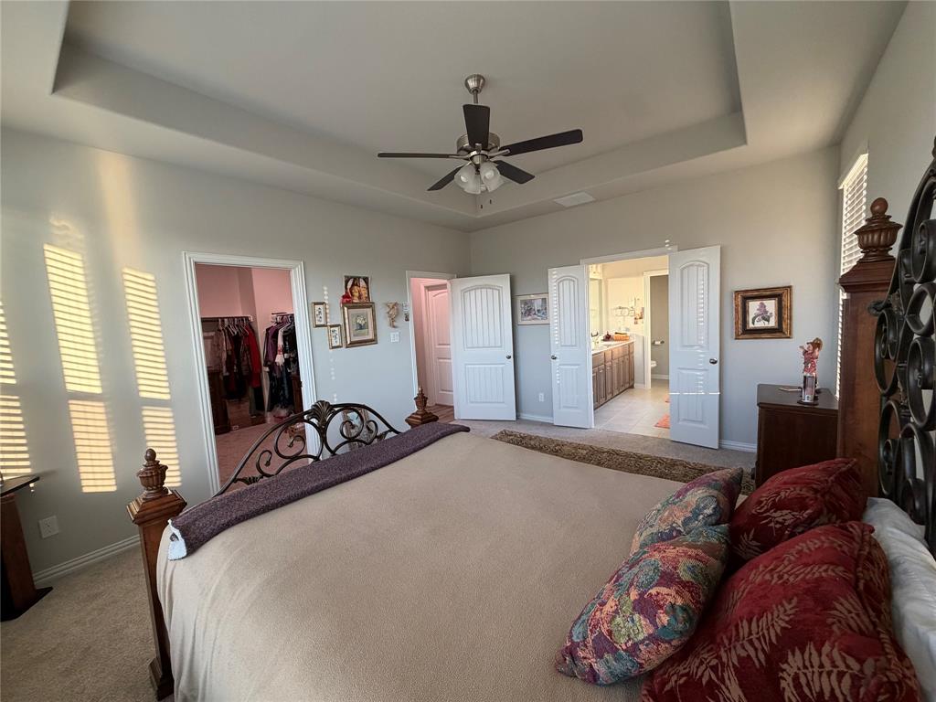 131 Llanos Drive Decatur, TX 76234 - Photo 5 of 9 Spacious room featuring tray ceiling, ceiling fan, and carpet flooring