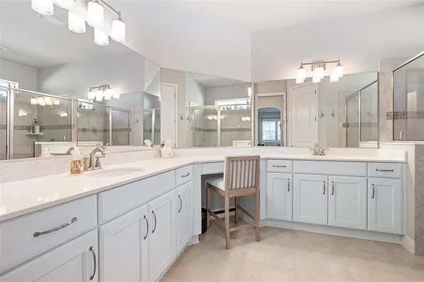 a bathroom with a sink vanity and a mirror