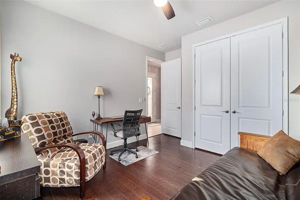 a living room with furniture and wooden floor