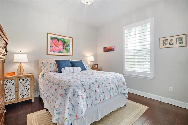 a bedroom with bed and wooden floor