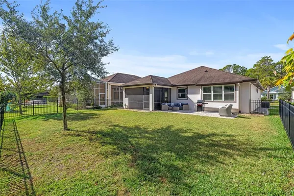 a house with huge green field in front of it