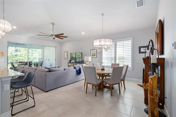 a living room with furniture a flat screen tv and a large window