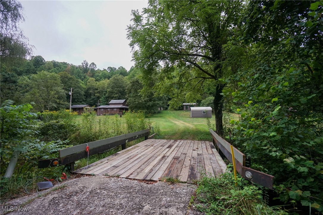 34799 Paw Road Lower Salem, OH 45745 - Photo 25 of 50 Wooden terrace with a shed, a lawn, and a forest view