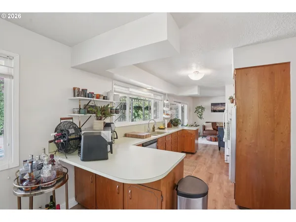 a kitchen with stainless steel appliances kitchen island granite countertop a table and chairs