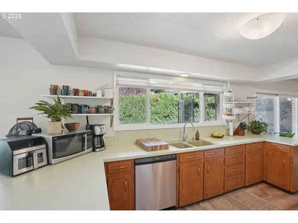a kitchen with a sink and a large window