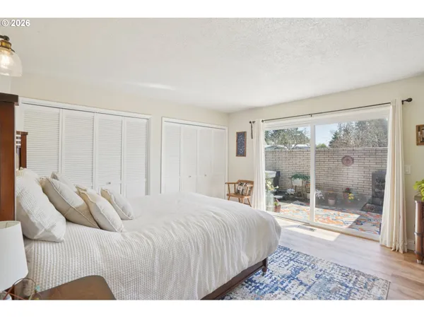 a bedroom with a bed and a large window