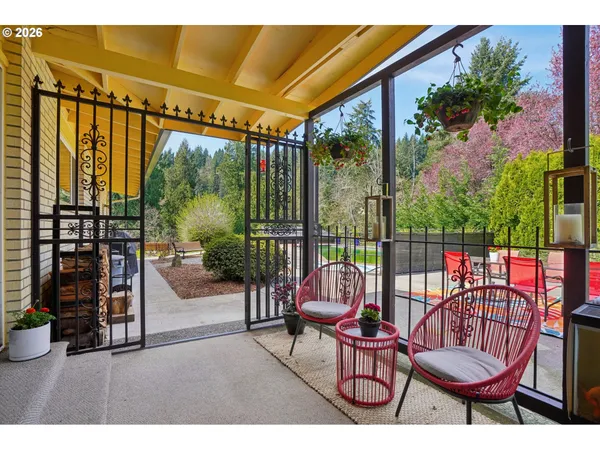 a view of a chairs and table in the balcony
