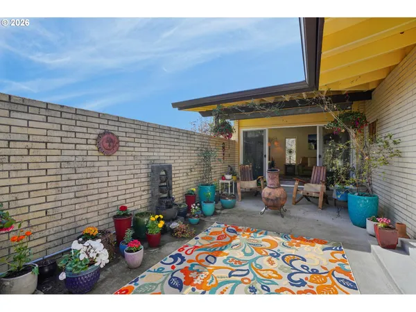 a view of a chairs and table in a patio