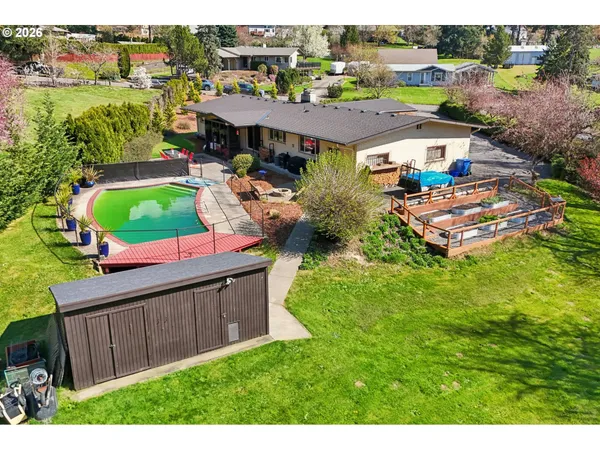 a aerial view of a house with a garden and lake view