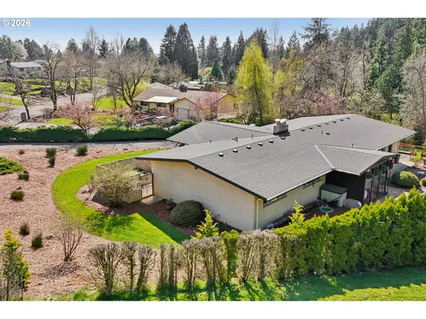 a view of a house with a swimming pool and a yard
