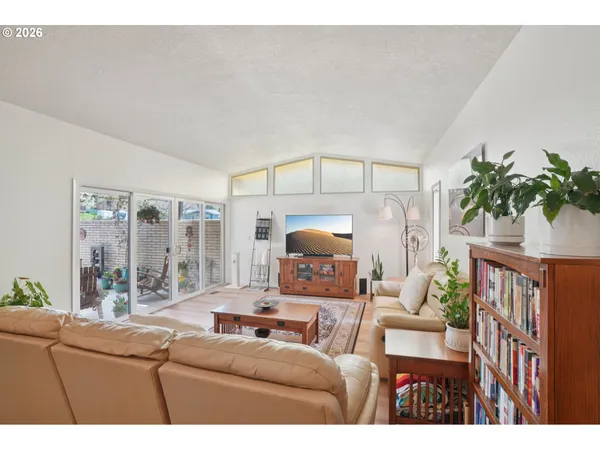 a living room with furniture a lamp and a potted plant