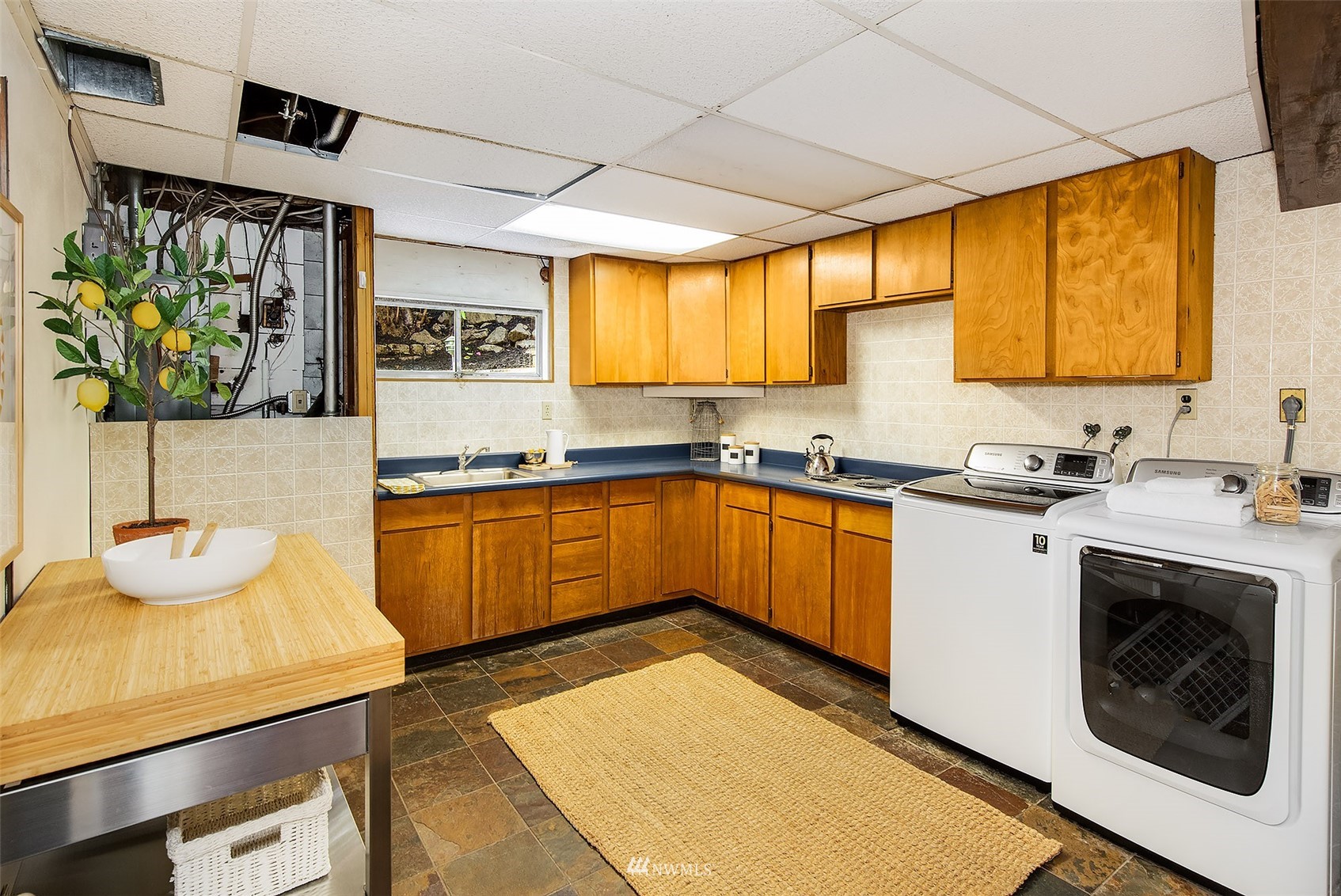 5540 Northeast Windermere Road Seattle, WA 98105 - Photo 21 of 40 a kitchen with stainless steel appliances a stove sink and cabinets