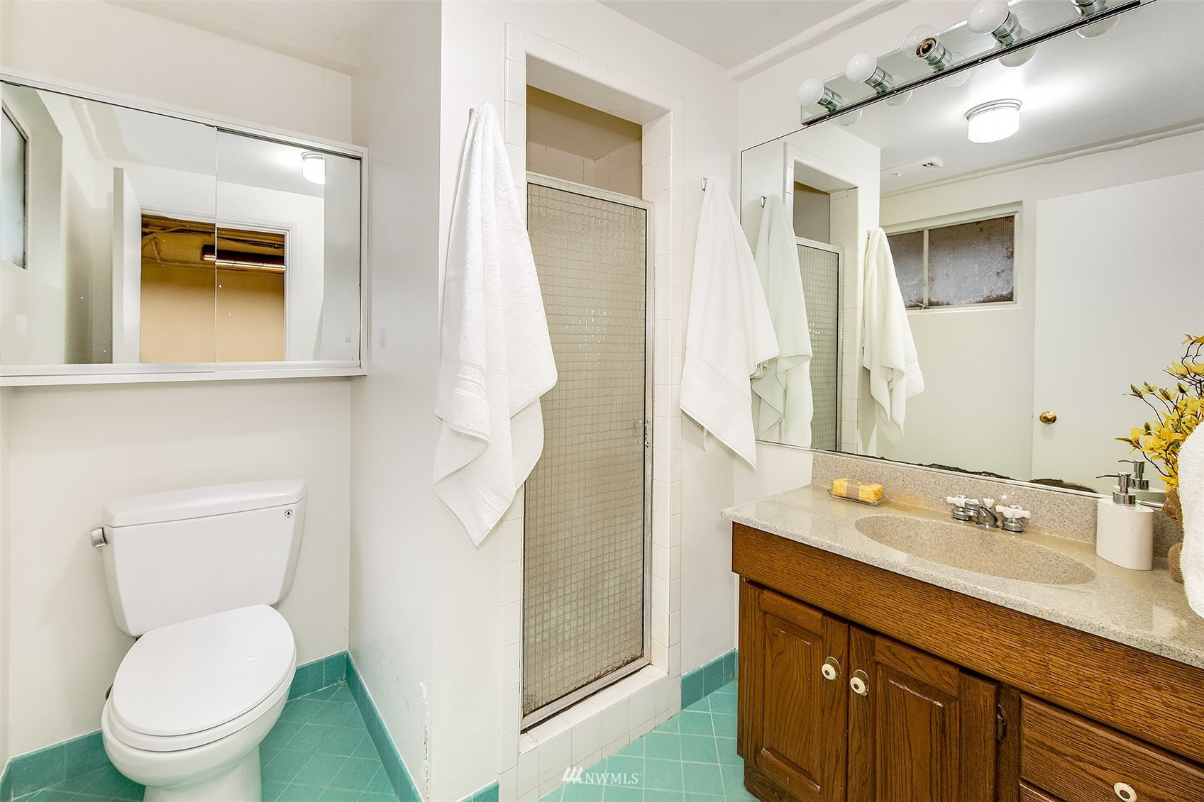 5540 Northeast Windermere Road Seattle, WA 98105 - Photo 22 of 40 a bathroom with a toilet sink and mirror
