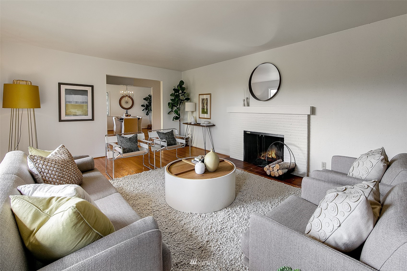 5540 Northeast Windermere Road Seattle, WA 98105 - Photo 5 of 40 a living room with furniture a fireplace and a large mirror
