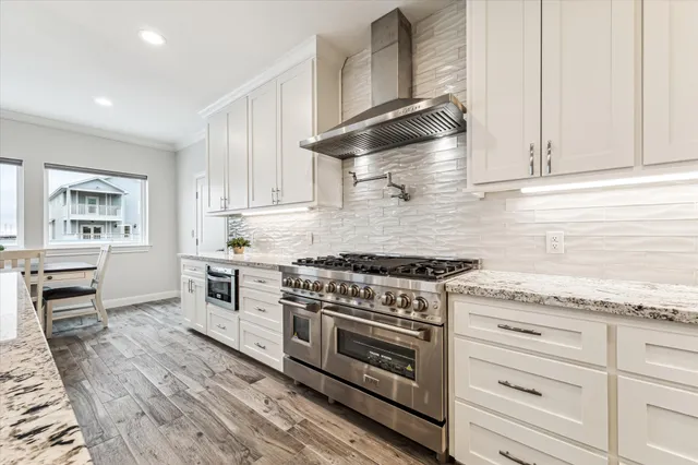 a kitchen with a stove sink and cabinets