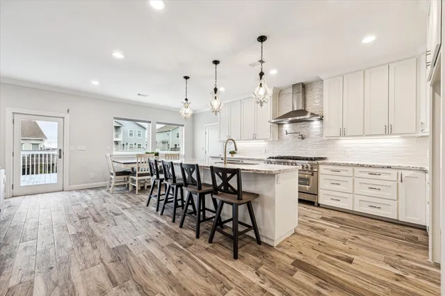 a large kitchen with kitchen island a sink a counter space and stainless steel appliances