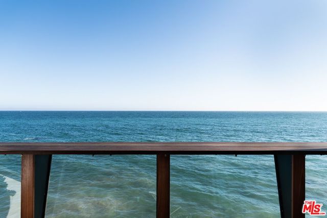 a view of a floor to ceiling window and an ocean view