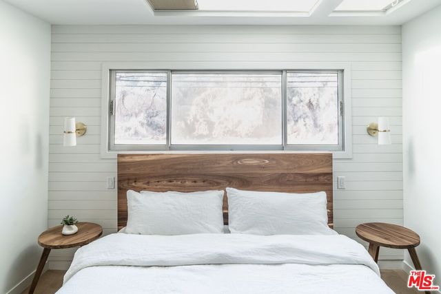 a bedroom with a large bed and a large window