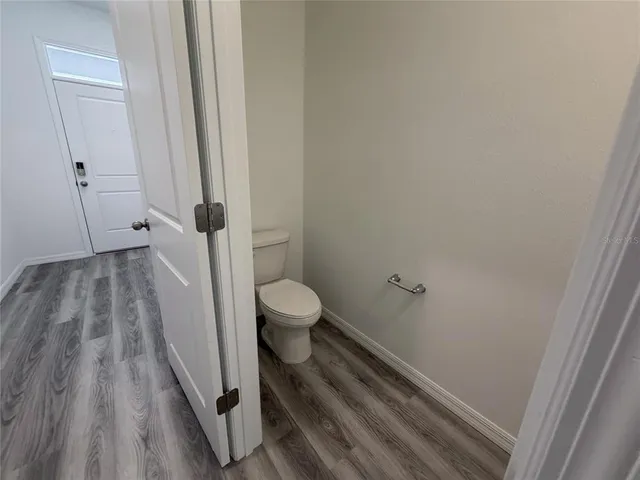 a bathroom with a sink mirror and toilet