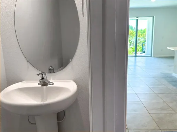 a view of a kitchen with sink and wooden floor
