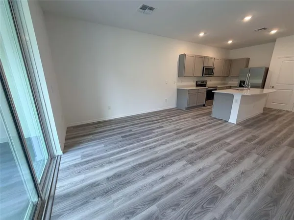 a view of kitchen with sink microwave and refrigerator