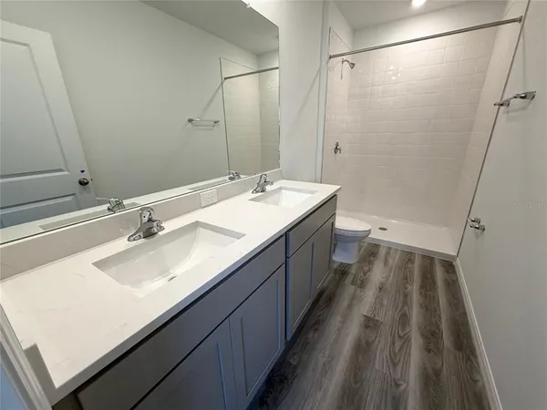 a bathroom with a double vanity sink and a mirror