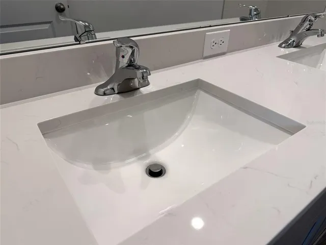 a bathroom with a double vanity sink and a mirror