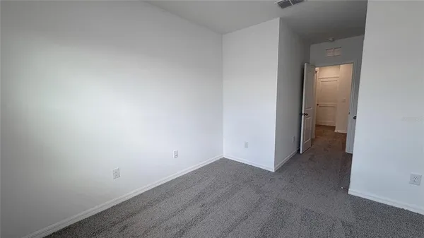 a view of water heater room with wooden floor