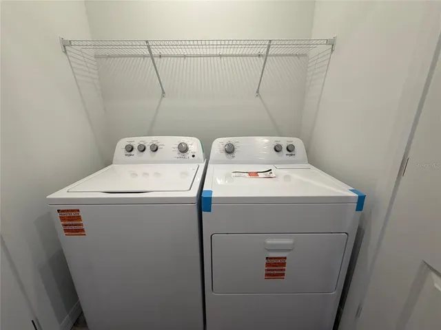 a view of water heater room with wooden floor