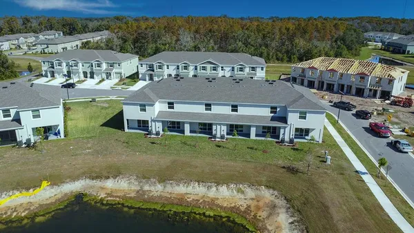 an aerial view of a house with garden space and street view