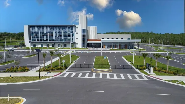 an aerial view of a house with a garden and lake view