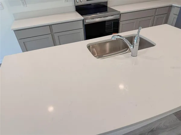 a kitchen with metallic refrigerator freezer and a dishwasher