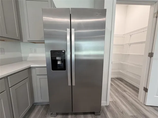 a kitchen with kitchen island wooden cabinets and stainless steel appliances
