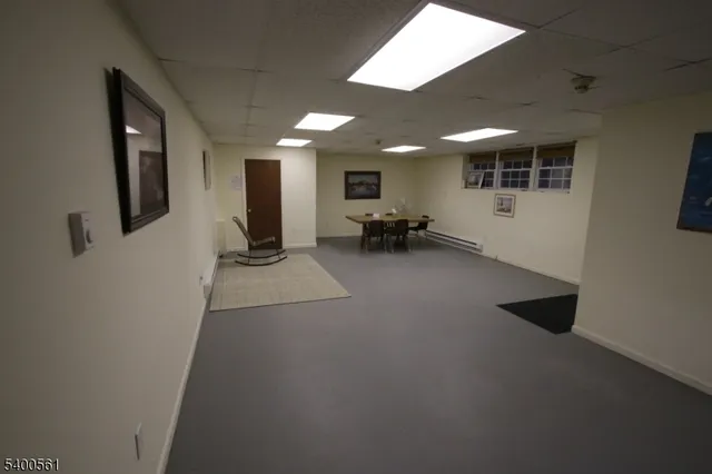 a view of a livingroom with furniture and a window