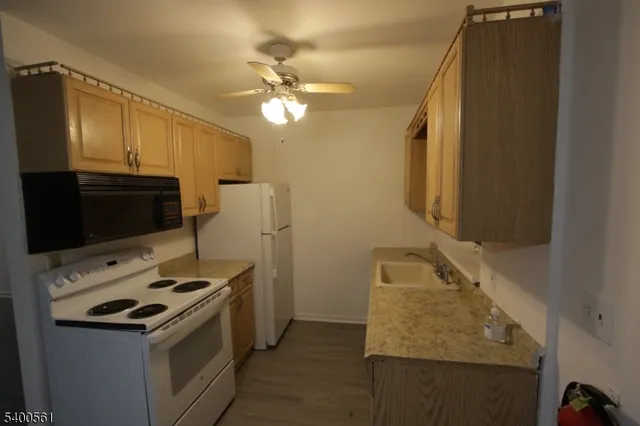 a kitchen with a sink appliances and cabinets
