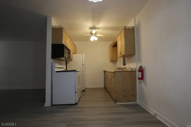 a view of a kitchen from the hallway